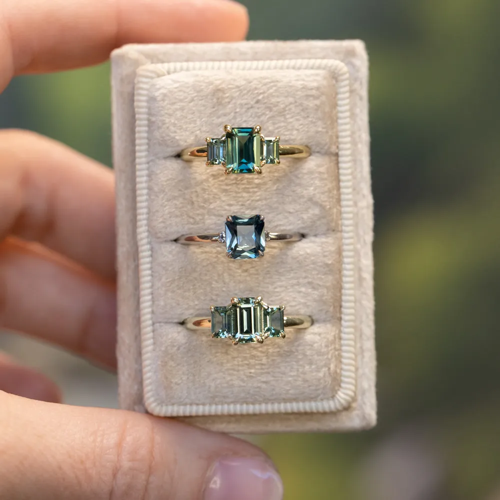 1.30ct Emerald Cut Madagascar Sapphire and  0.98ctw Montana Sapphire Three Stone Low Profile Ring in 18k Yellow Gold