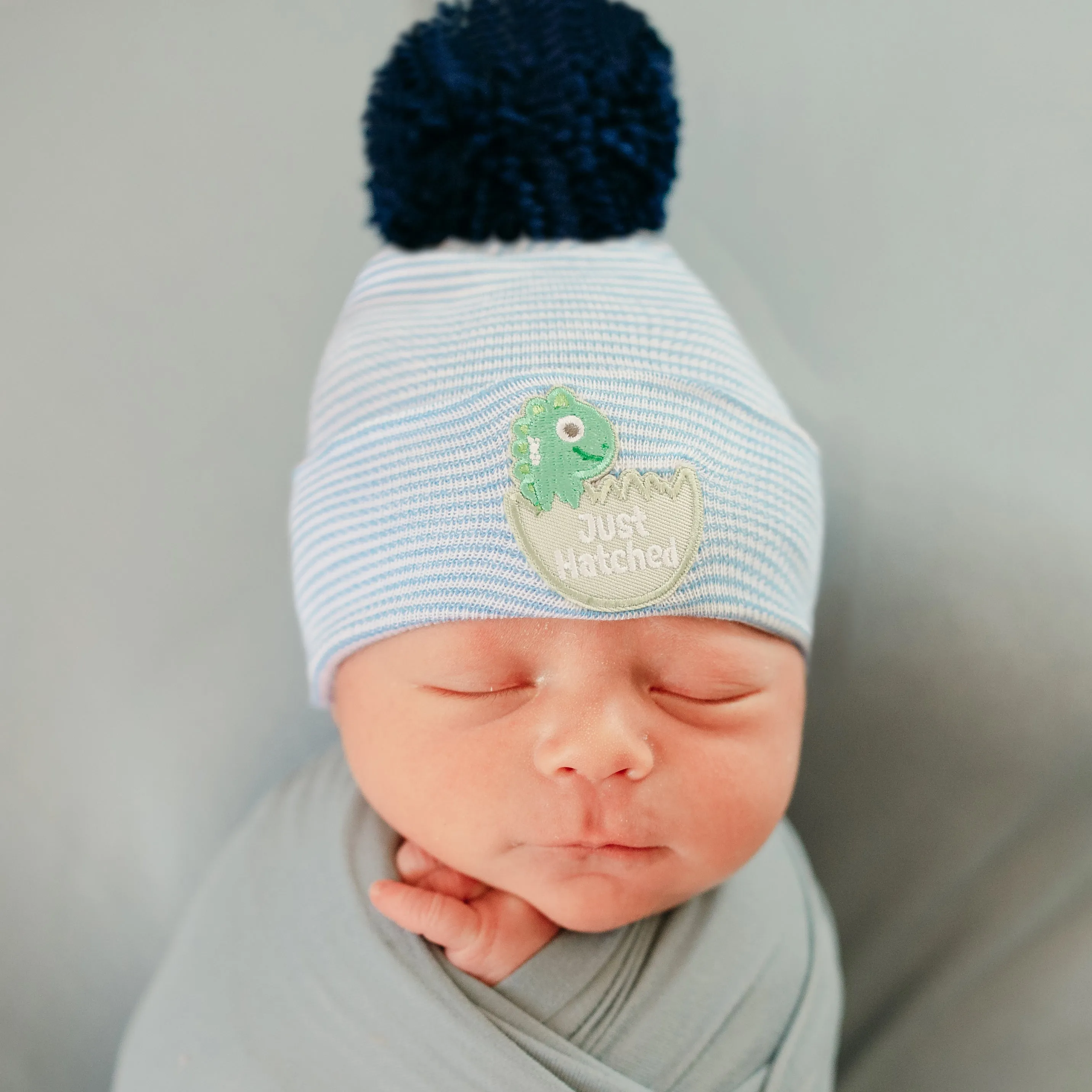 ilybean JUST HATCHED Striped Blue and White Striped Newborn Boy Hospital Hat with Navy Pom